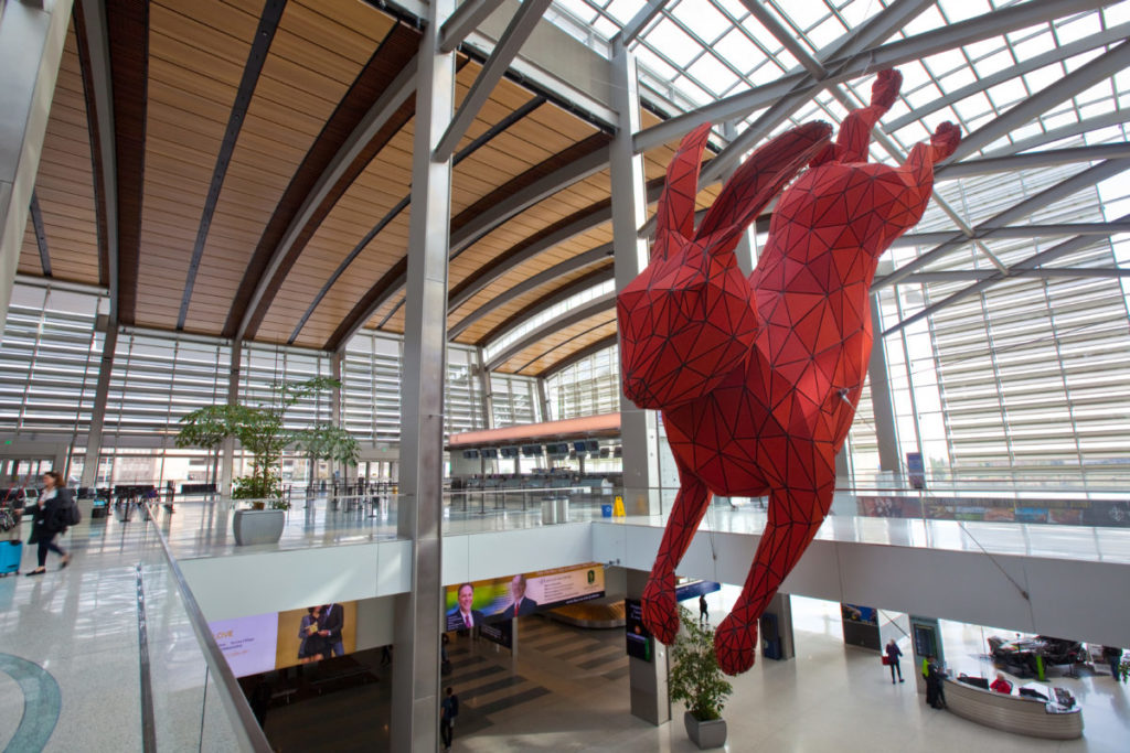 SACRAMENTO, CALIFORNIA - FEBRUARY 5, 2017: Large red rabbit sculpture hangs over the baggage claim area of Terminal B at Sacramento International Airport.